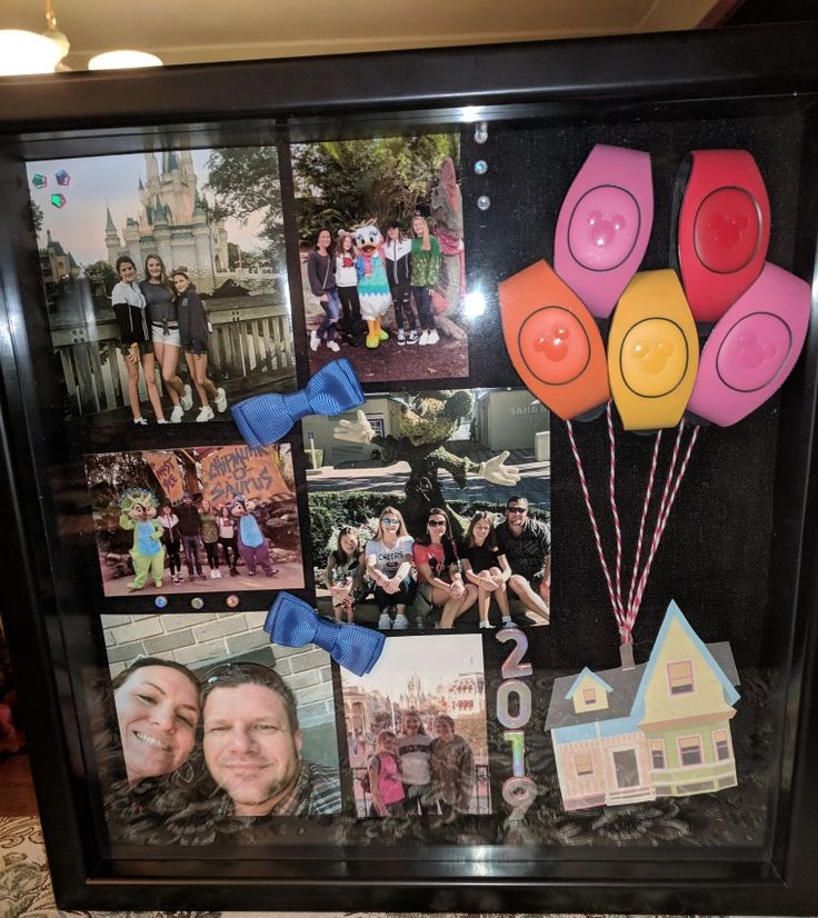 a collage of photos and balloons is displayed in a black frame on the floor