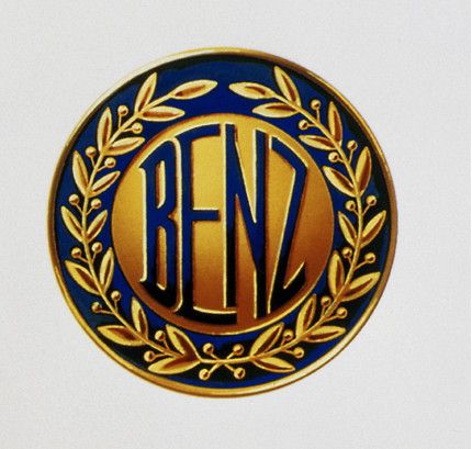 a blue and gold medallion with the word ben in it's center surrounded by leaves