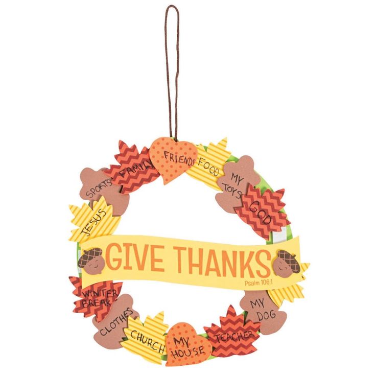 a wreath ornament with the words give thanks on it