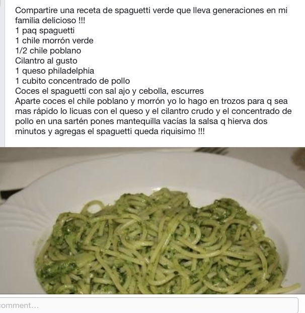 a white plate topped with pasta covered in pesto