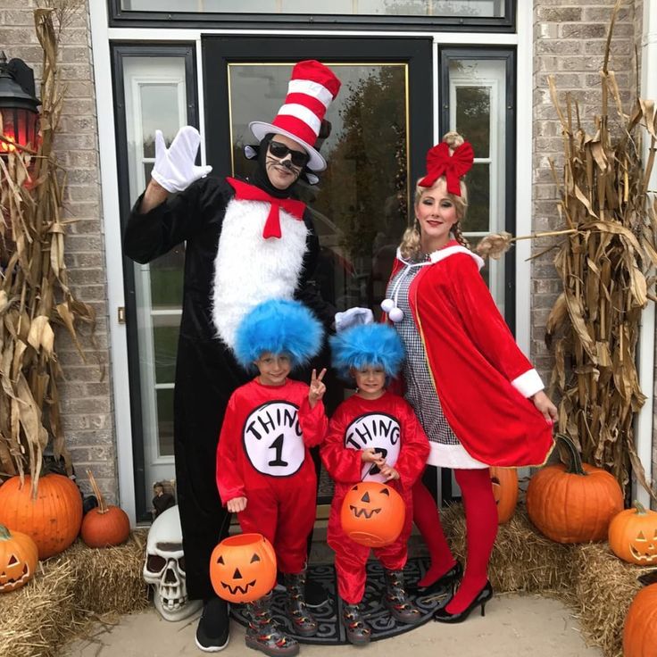 the cat in the hat family is posing for a photo outside their front door with pumpkins