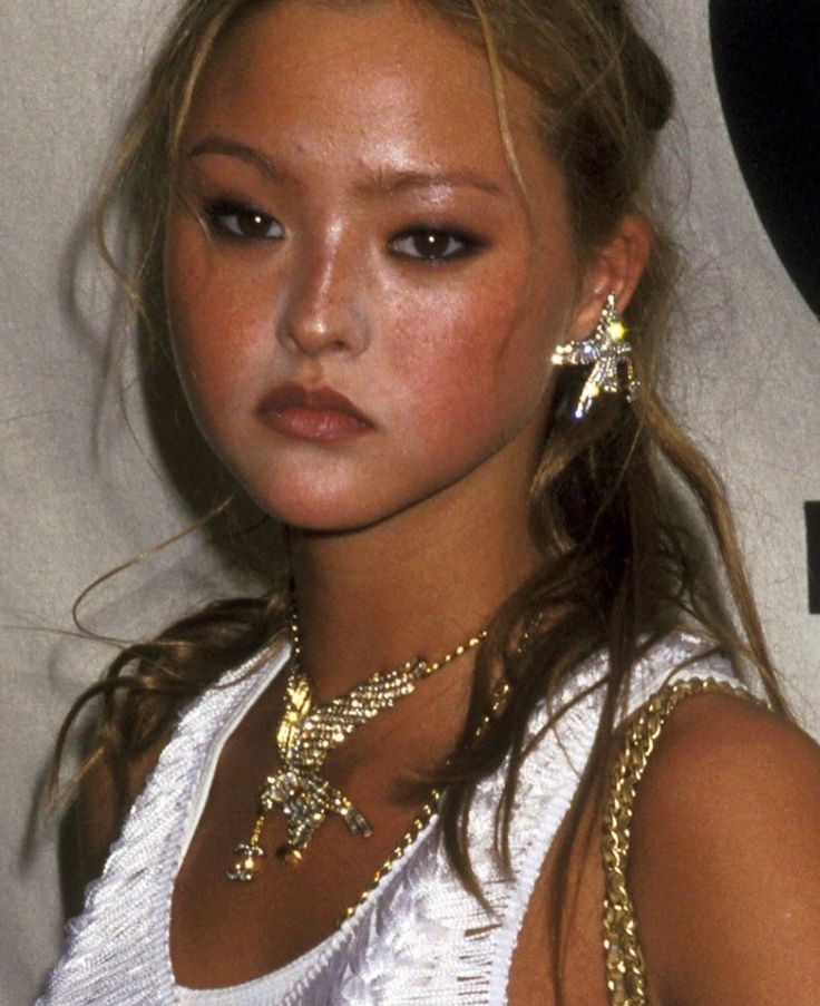 a close up of a person wearing gold jewelry