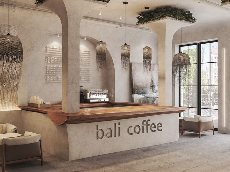 the interior of a coffee shop with chairs, tables and lamps hanging from the ceiling