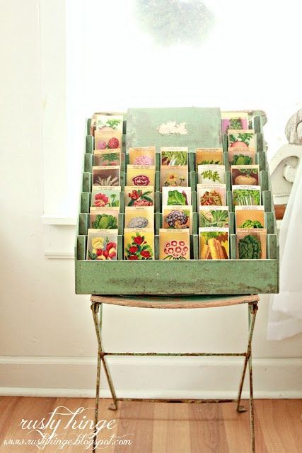 a green chair sitting in front of a window filled with lots of different types of cards