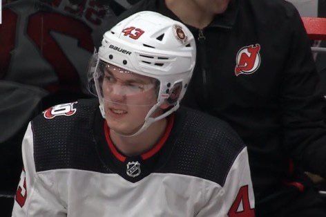 a hockey player is sitting in the bench