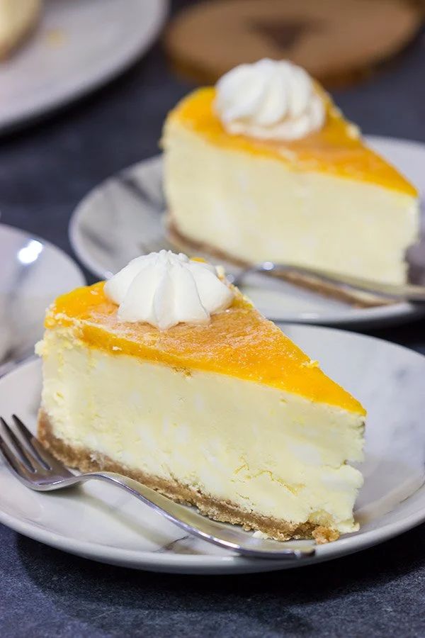 two slices of cheesecake with whipped cream on top