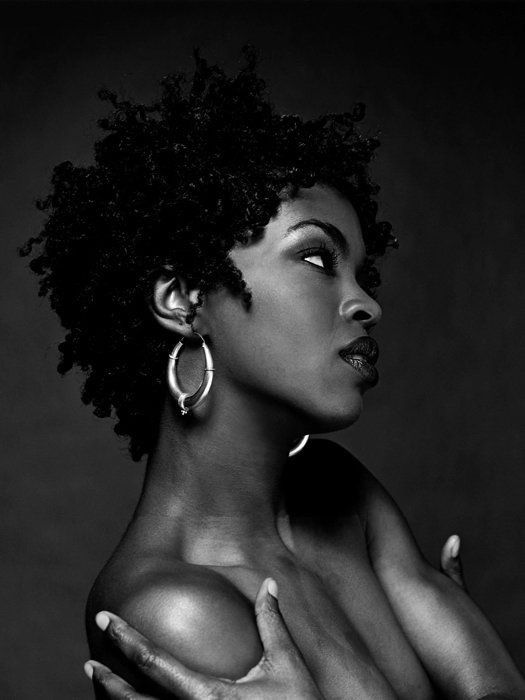 a black and white photo of a woman with large hoop earrings