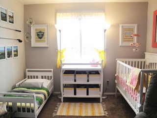 a baby's room with two cribs in it