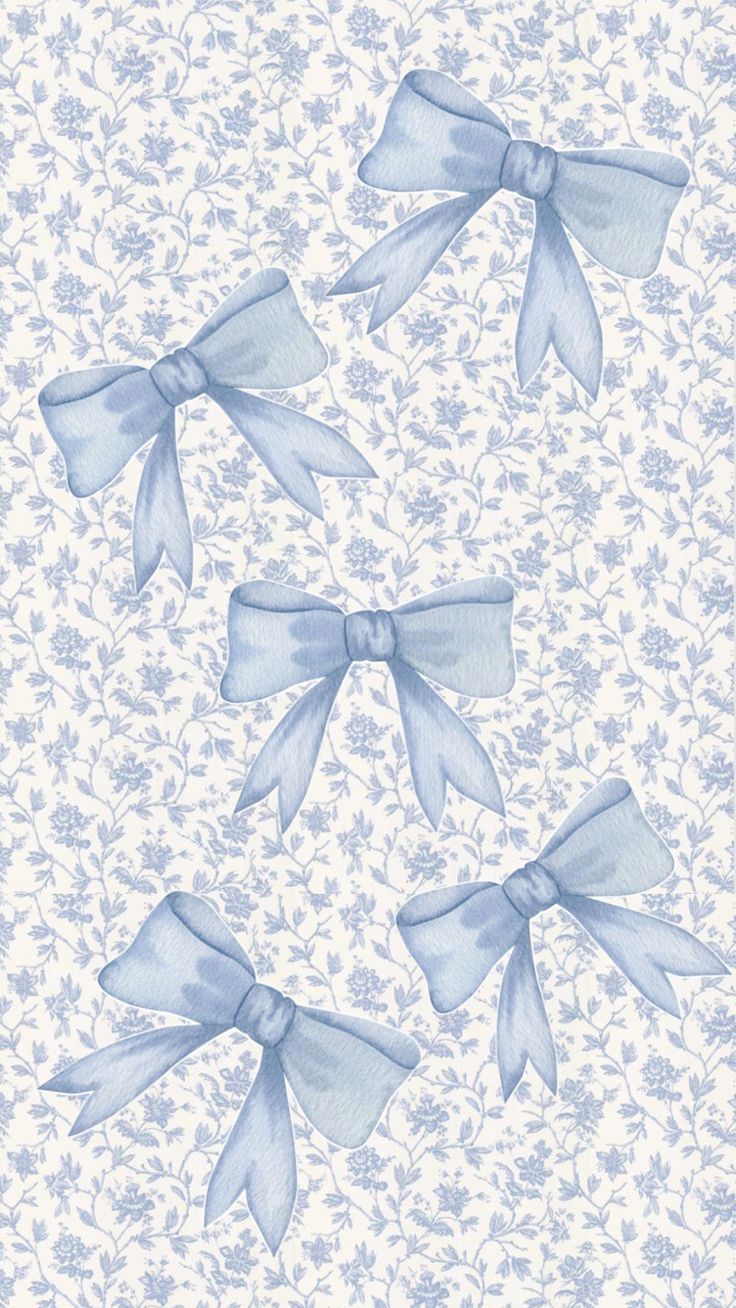 three blue bows on a white wallpaper with small flowers and leaves in the background