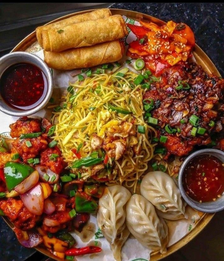 a plate filled with different types of food and condiments on top of it