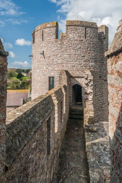 the entrance to an old castle on a sunny day