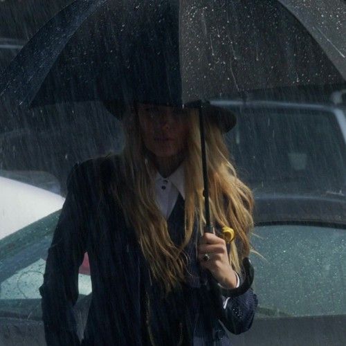 a woman holding an umbrella in the rain