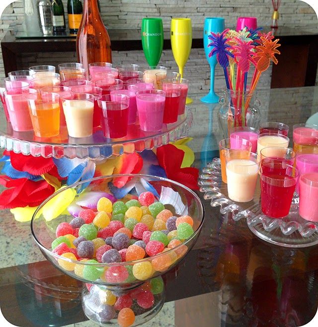 there is a glass bowl filled with candy and candles on the table next to it