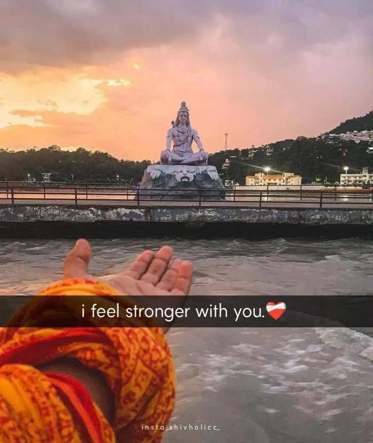 someone is holding their hand up in front of a statue with the words, i feel stronger with you