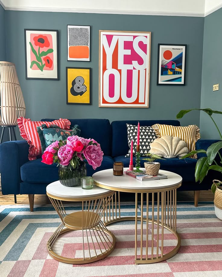 a living room filled with furniture and pictures on the wall above it's coffee table