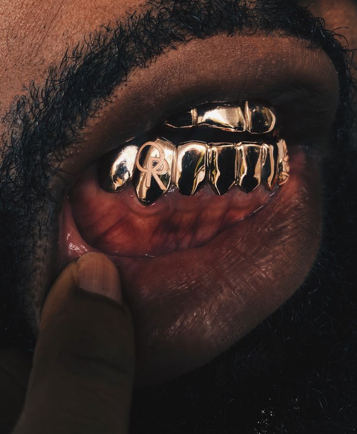 a close up of a person's gold teeth