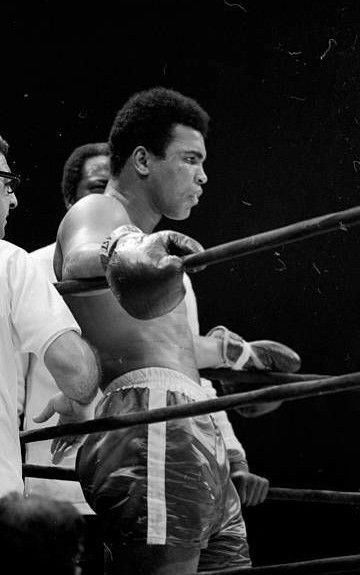 two men standing next to each other in a boxing ring