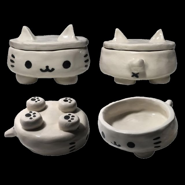 three ceramic bowls with cats faces and paws on the top one has a cat's head