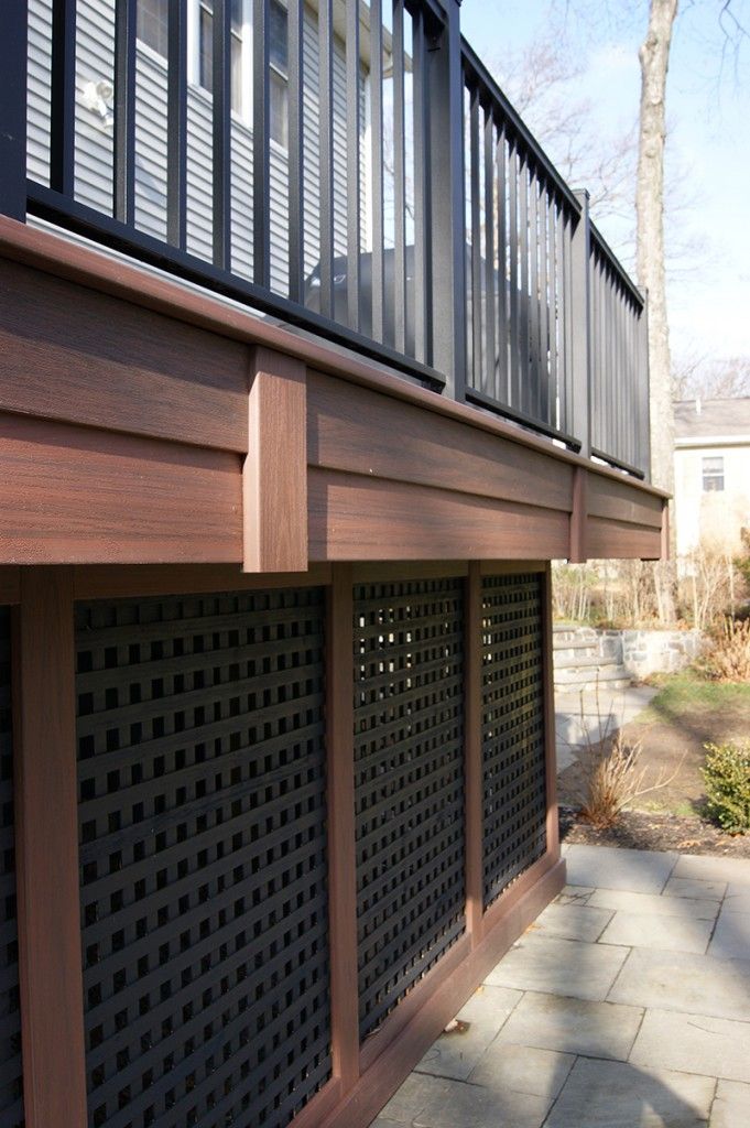 the side of a house with a wooden balcony