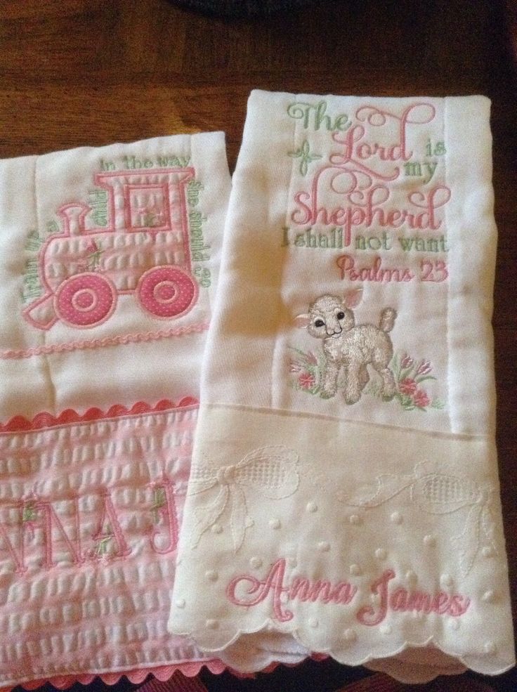 two pink and white embroidered handkerchiefs on a table