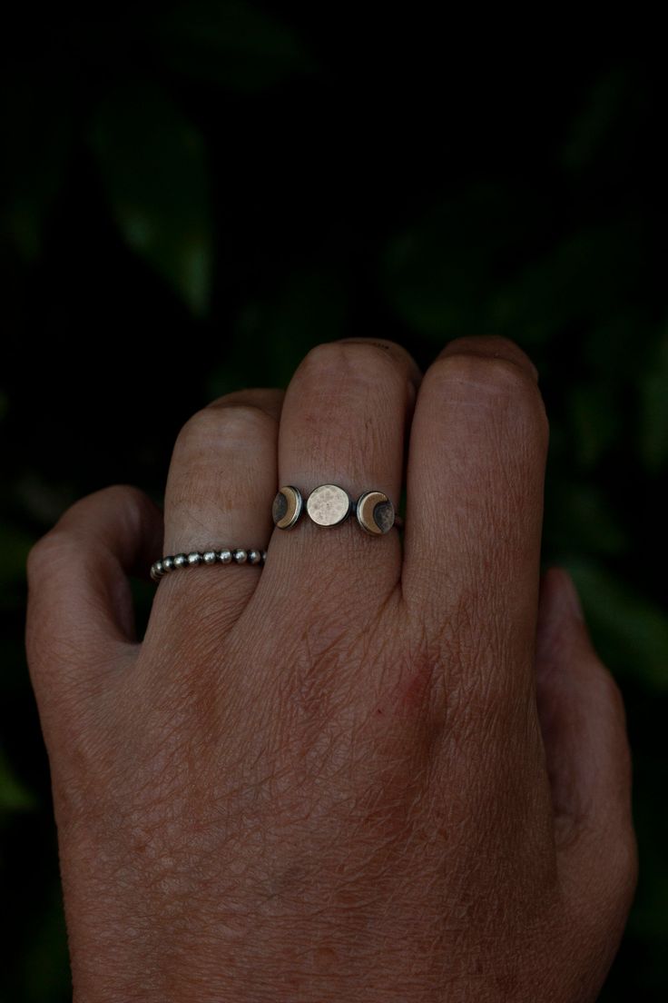 This triple goddess moon ring is super comfortable to wear and unlike triple moon rings that don't have the sterling silver full moon backing, it won't get caught on things. I have very active hands so I wanted to create a triple moon ring that could be worn easily and comfortably daily. A hand textured 7mm round raw brass full moon and two smooth crescent moons sit on top of sterling silver discs creating a moon trinity. A patina has been added to give this ring a rustic, more realistic look. P Brass And Silver Jewelry, Mystical Adjustable Moon Phase Rings, Spiritual Sterling Silver Rings With Moon Charm, Spiritual Moon Charm Promise Ring, Bohemian Moon Phase Ring, Adjustable Moon-shaped Spiritual Ring, Spiritual Crescent Moon Charm Ring, Mystical Moon Phase Ring, Bohemian Crescent Moon Phase Ring