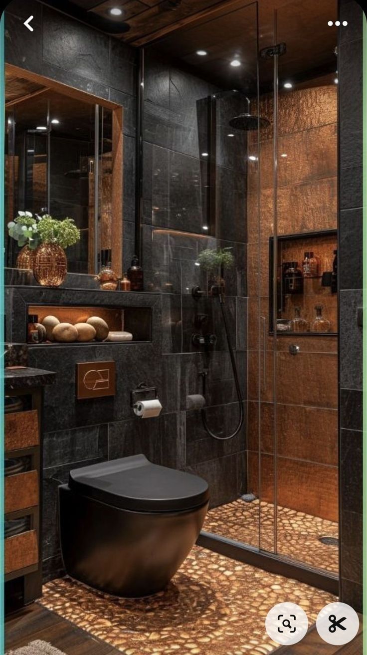 the bathroom is decorated in black and gold