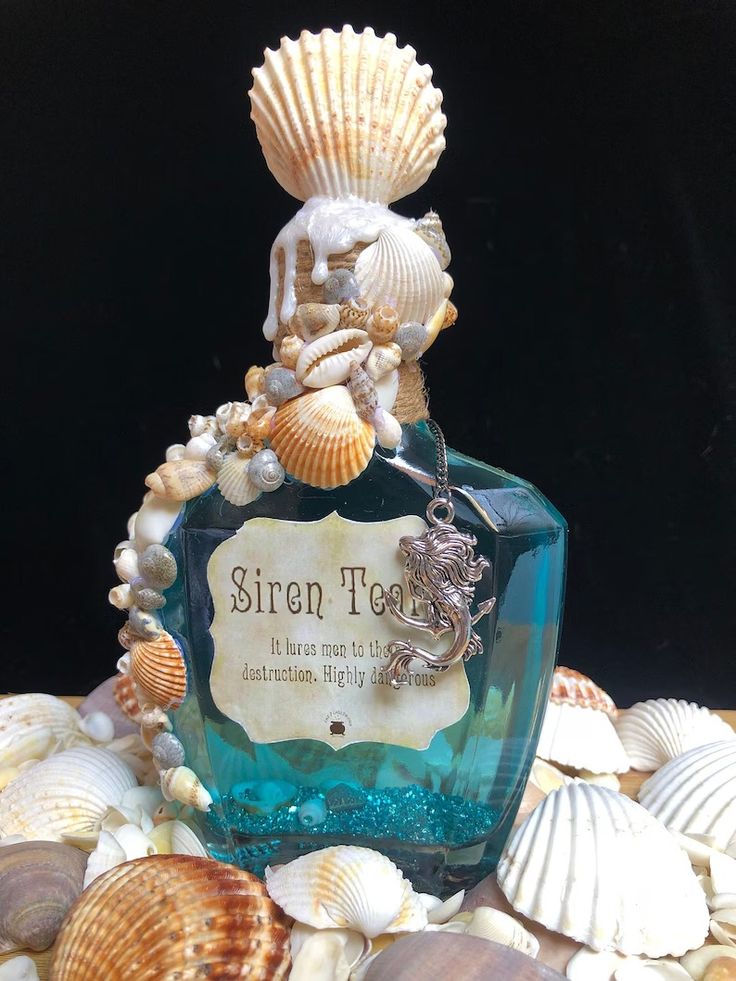 there is a bottle that has some shells on it and the label says siren tea