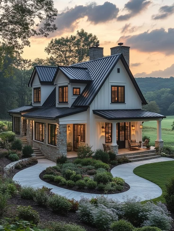 a large white house with black roof and lots of windows on the side of it