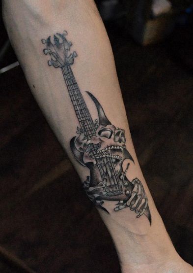 a person with a guitar tattoo on their foot