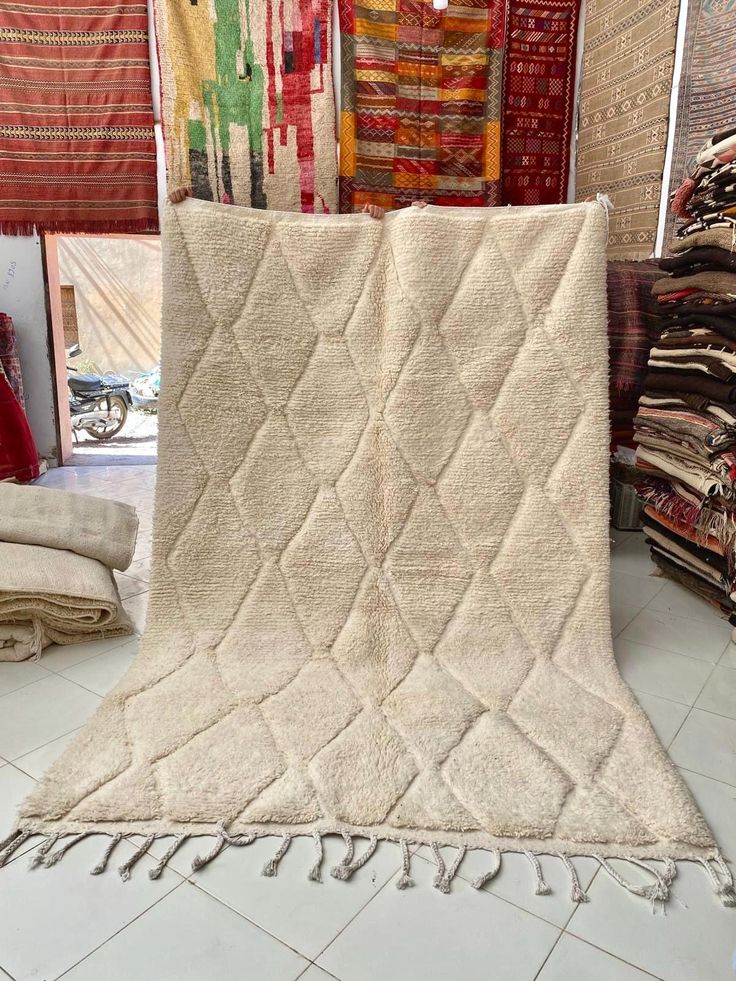 a pile of rugs on display in a store