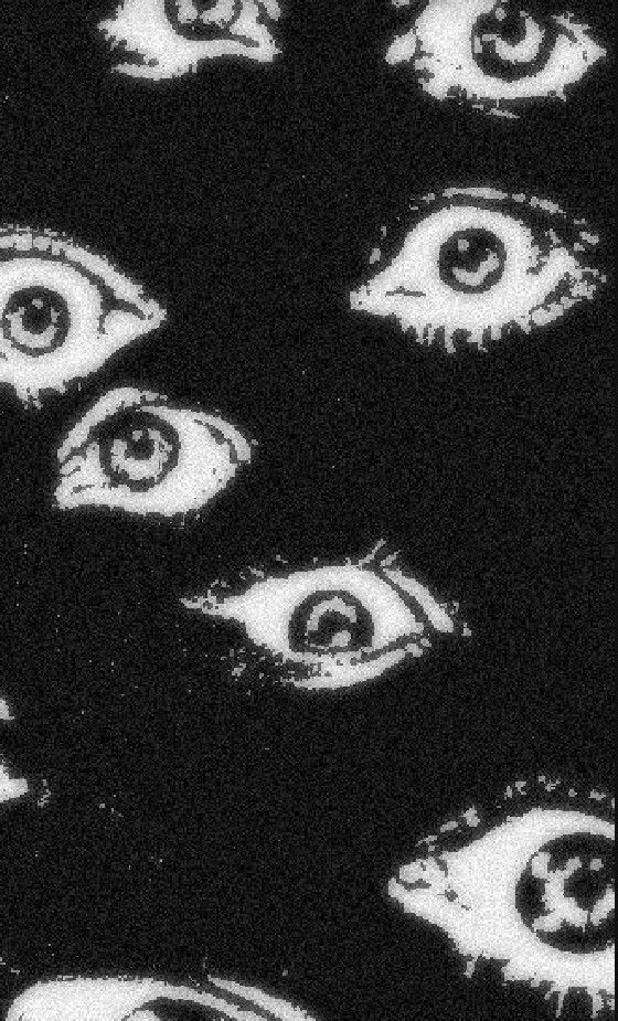 an image of many eyes in the dark