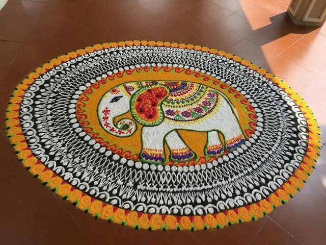 an elephant is painted on the floor with colorful colors and patterns, as well as flowers