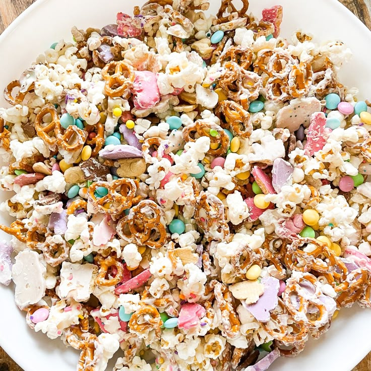 a white plate topped with lots of candy popcorn