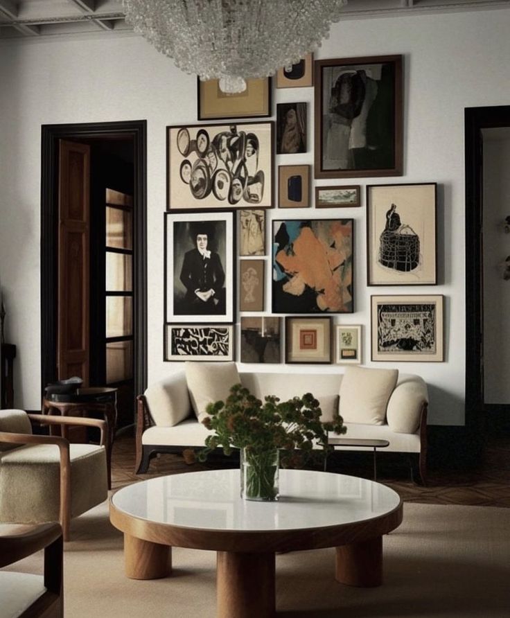 a living room filled with furniture and pictures on the wall