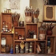 the shelves are filled with many different types of art supplies and paintbrushes on them