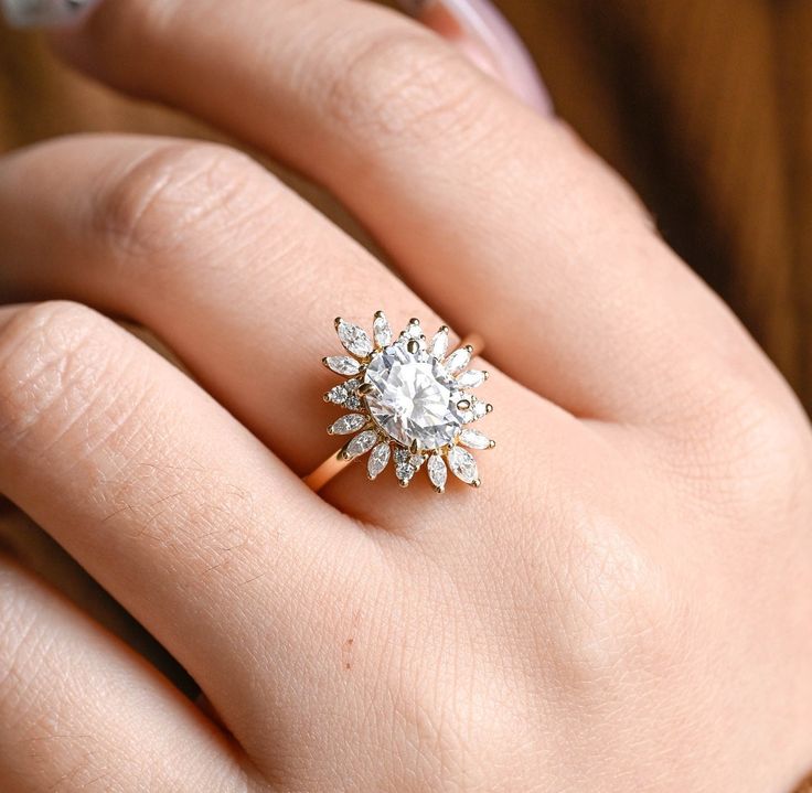 a woman's hand with a diamond ring on it