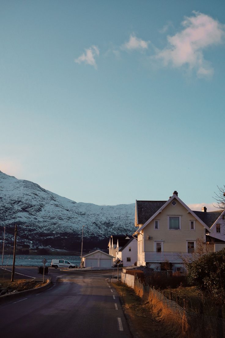 a street with houses and mountains in the background