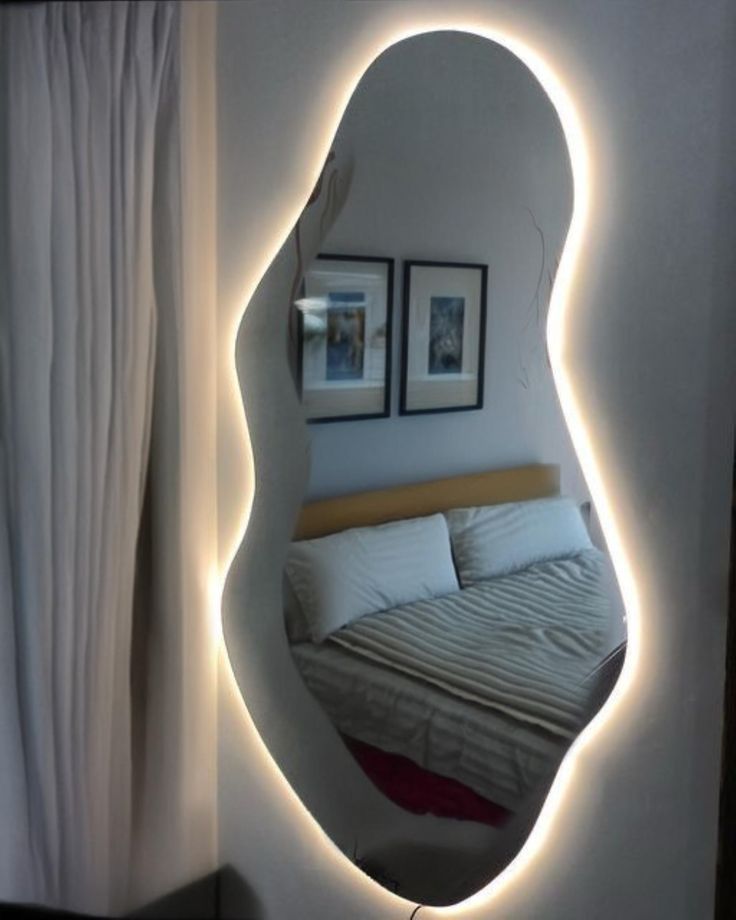 a bedroom with a large mirror on the wall above it and lights in the corner