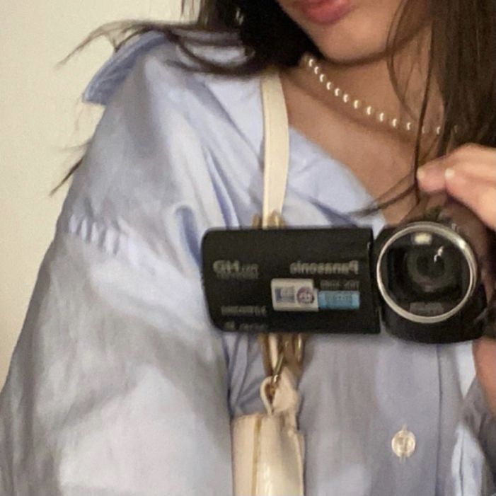 a woman holding a camera up to her face