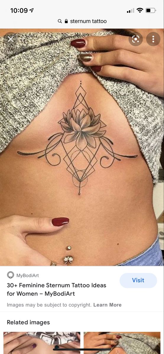 a woman's stomach with a lotus tattoo on the side and words below it