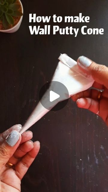 two hands are holding a white cone with the words how to make wall putty cone