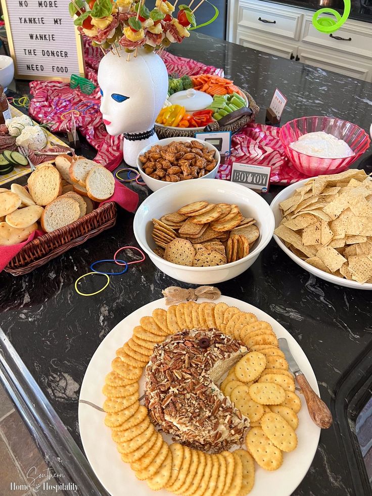 a table topped with plates filled with crackers and other snacks on top of it