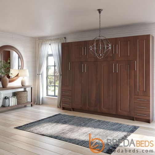 a room with wooden furniture and a large mirror on the wall next to a window