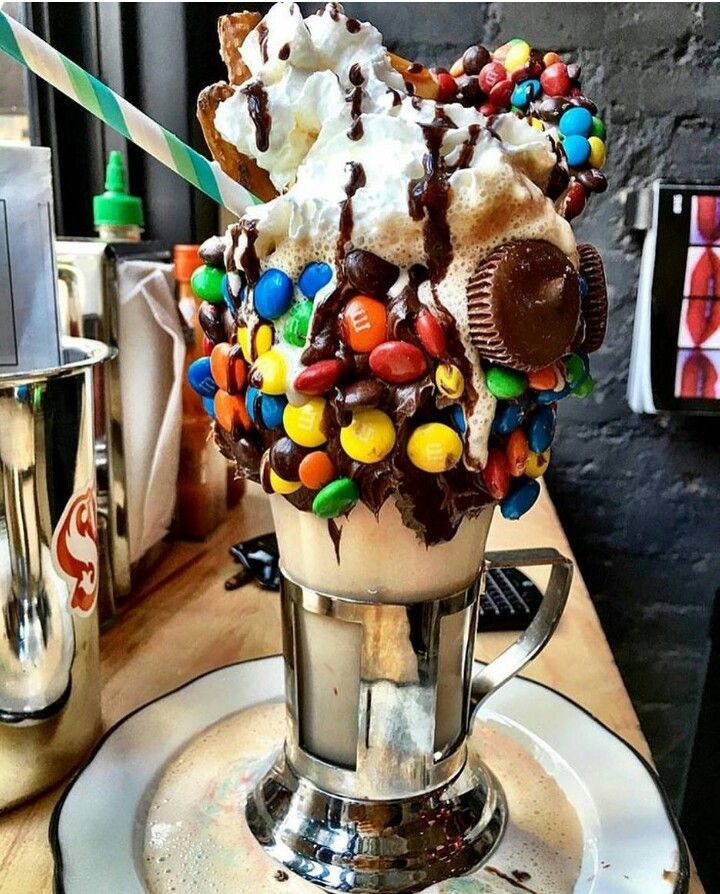 an ice cream sundae with chocolate, candy and marshmallows on top