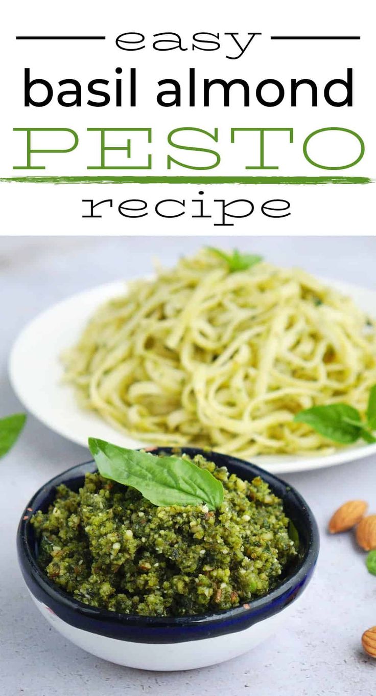 basil pesto pasta in a white bowl with almonds and basil leaves on the side