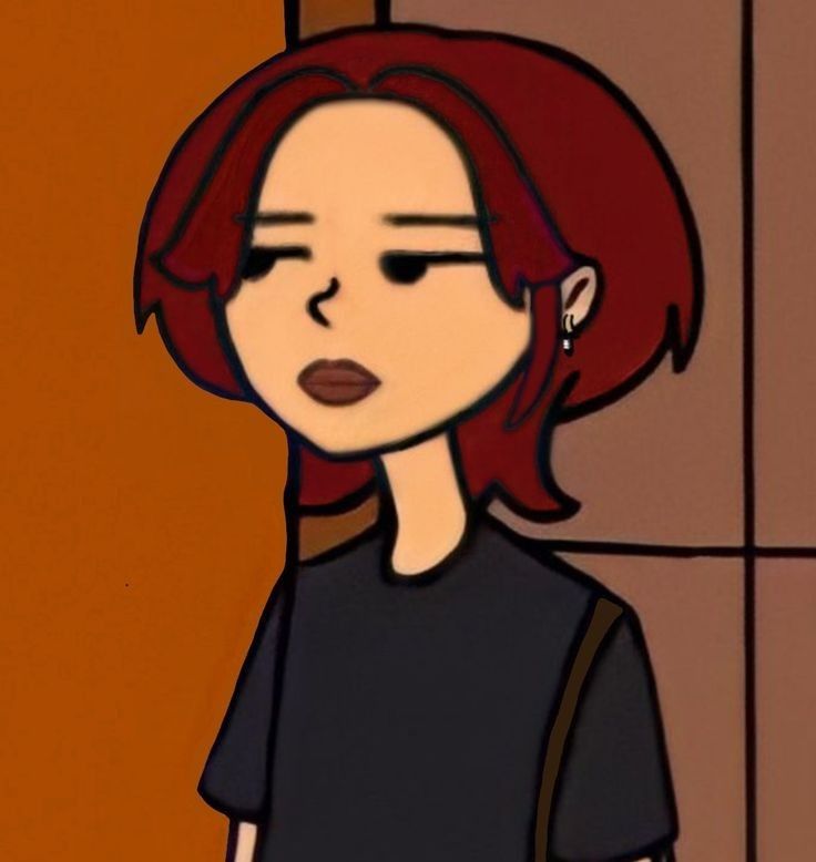 a woman with red hair and black shirt standing in front of a wall