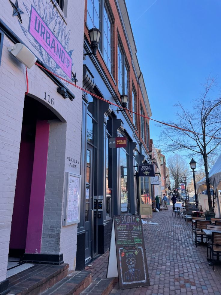 an empty sidewalk in front of a restaurant