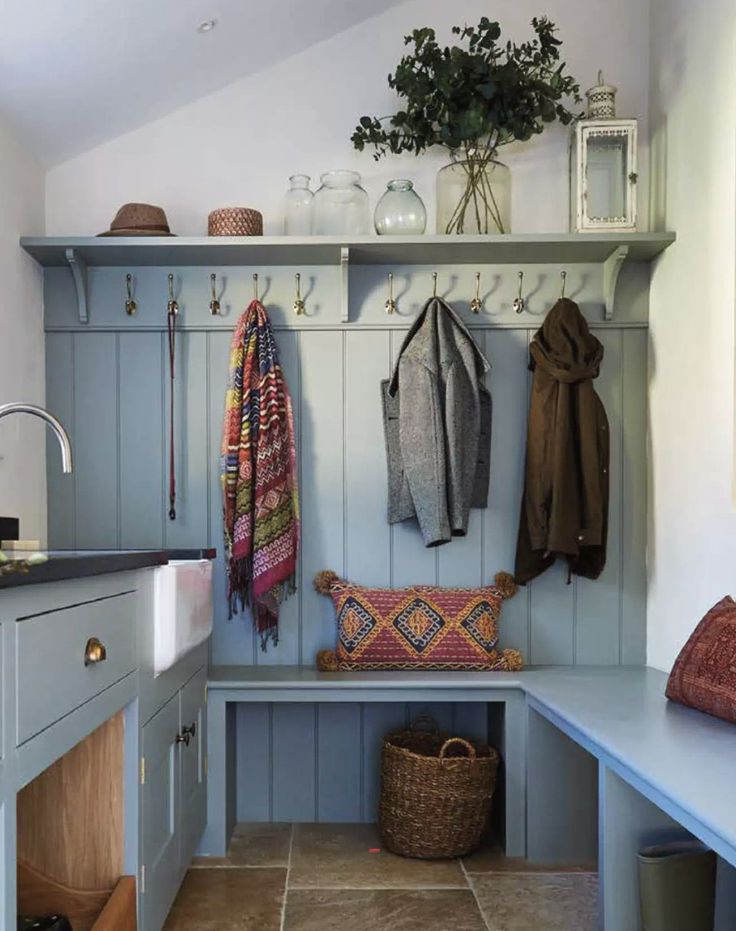 a blue bench sitting under a window next to a potted plant on top of a wooden shelf