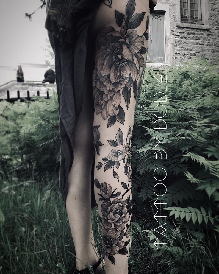 an instagram photo with flowers and leaves on the leg, in black and white