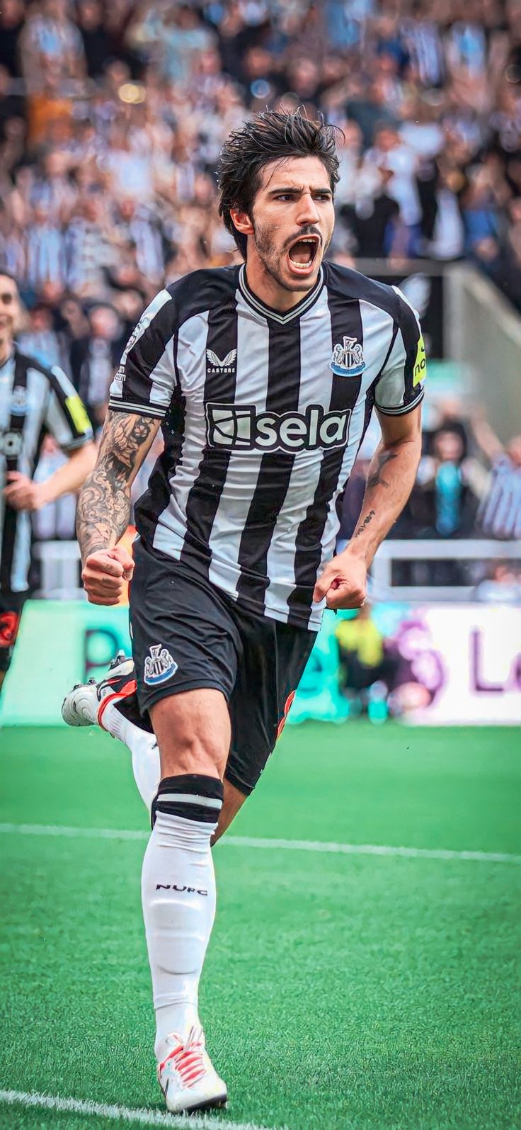 a soccer player is running on the field with his mouth open and eyes wide open